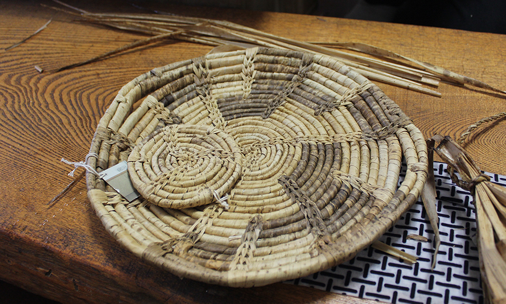 竹皮で編んだ竹皮編のコースターとトレイ。白いところはカシロダケ、色の黒いところはマダケを使用しています。今回使用するのはマダケになります。